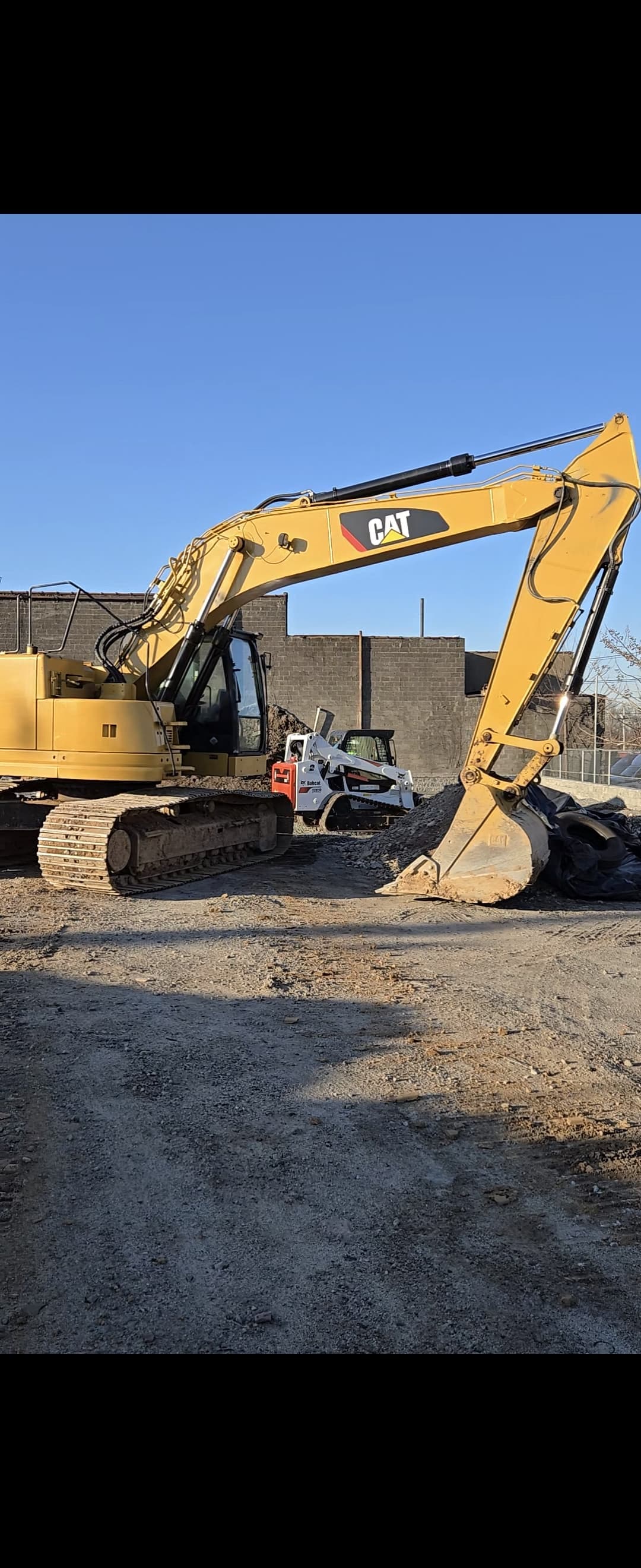 large yellow CAT excavator on construction site