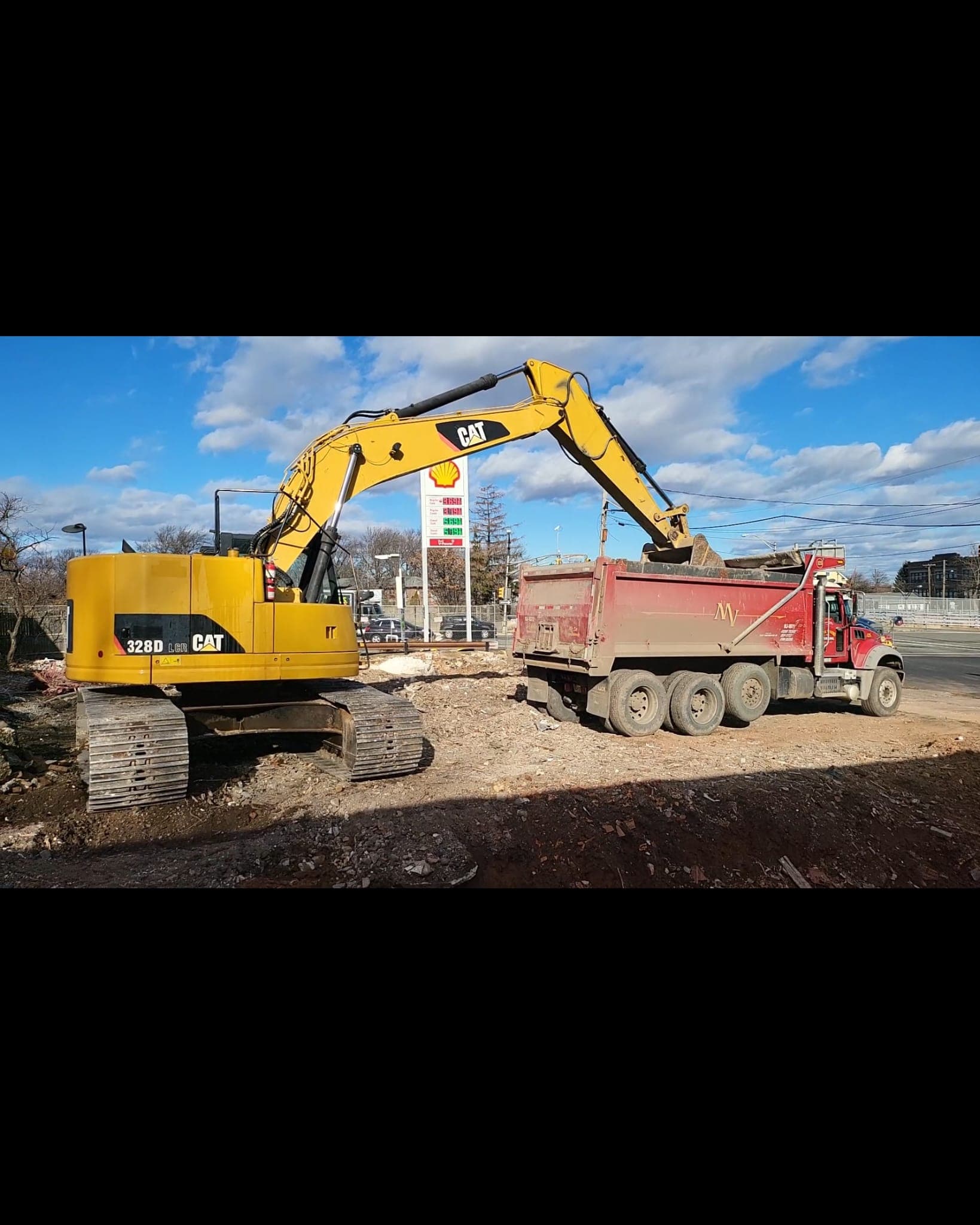 excavator loading a dump truck